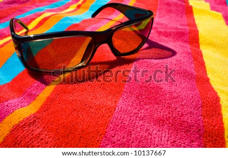 sunglasses on bright beach towel