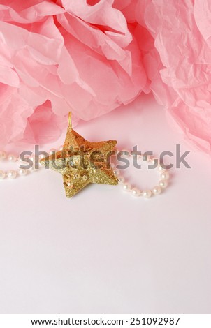 Decorative star, pearl beads and pink and white pom pom.Greeting or invitation card with copyspace