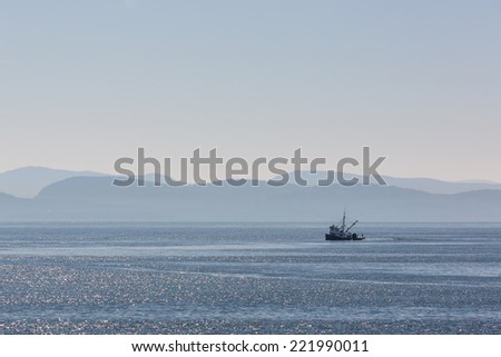 A fishing boat on a misty morning in the street of Georgia, Vancouver island
