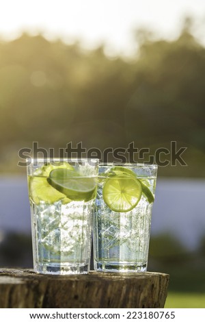 A glass of Lemon Lime soda filled with ice cubes, soda