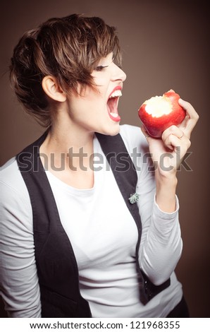 Woman about to take a bite of an apple