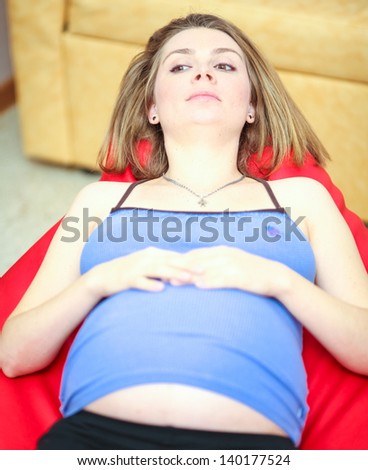 Pregnant woman in armchair in delivery room