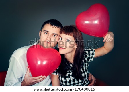 Loving couple with balloon hearts