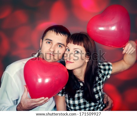 Loving couple with balloon hearts