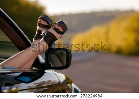 Woman legs from a car window