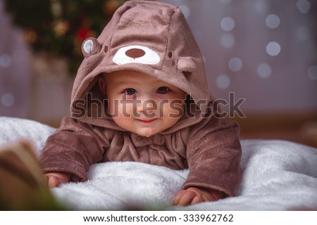 Happy infant baby boy in christmas decorations closeup