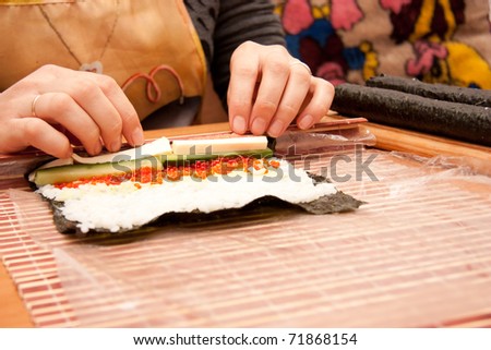 Making Rolled Sushi in a Bamboo Sushi Mat