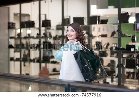 Beautiful woman at the shopping center with bags