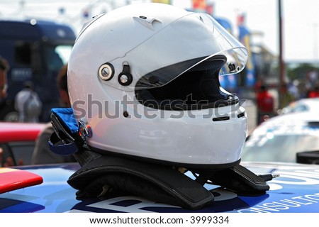 racing helmet on top of a racing car