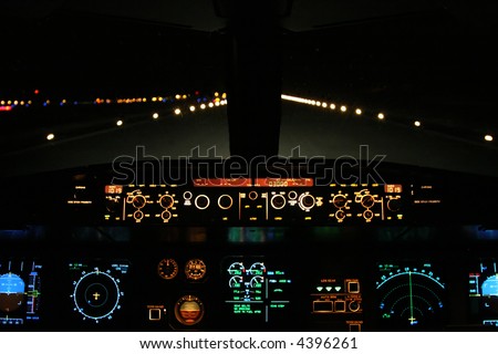 aircraft landing at night with runway ahead