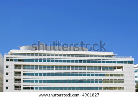 office building against a bright blue sky - put your logo on top