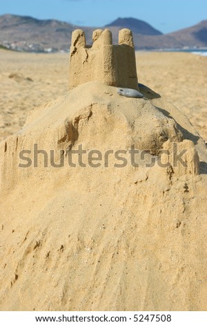 sand castle by the sea with beach as background
