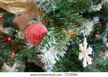 red christmas ball on a christmas tree with glow effect
