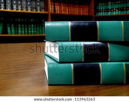 Row of old leather books on a desk or table with blank covers