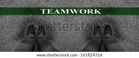 Businessmen standing on asphalt starting line with motivation word of Teamwork
