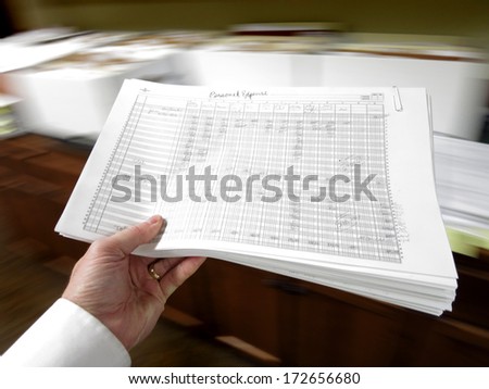 Businessman in office holding packet of documents