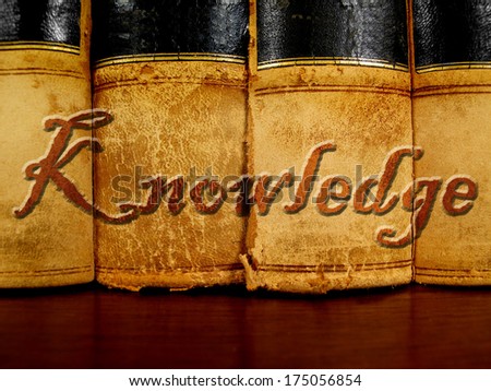 Row of old leather books on a shelf with word knowledge cover