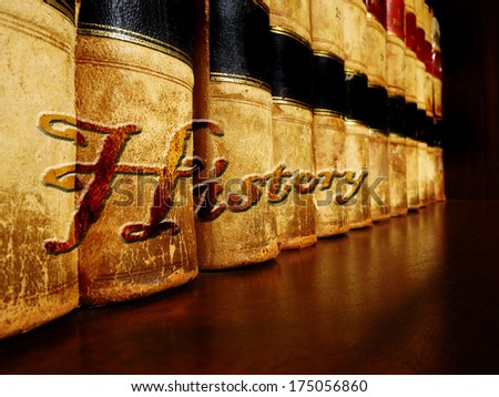 Row of old leather books on a shelf with word History cover