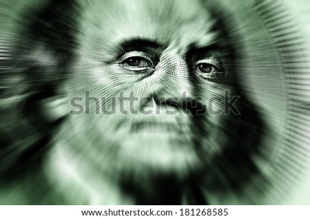 Closeup of hundred dollar bill isolated on Franklin portrait zoomed to eyes