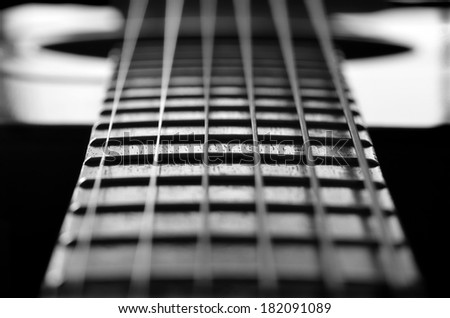Closeup detail of steel guitar strings and frets for making music