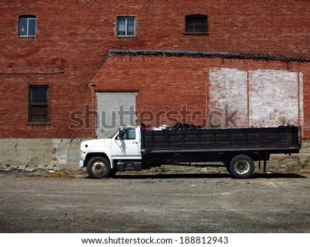 Industrial large dumptruck dump truck and brick building