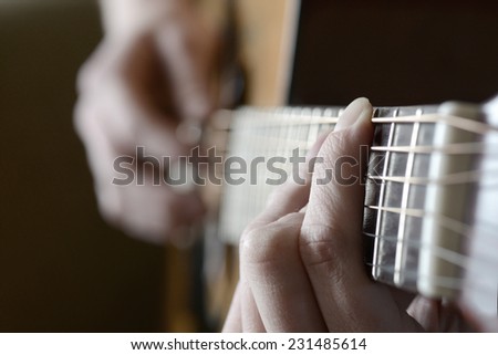 Playing guitar strings and frets for making music