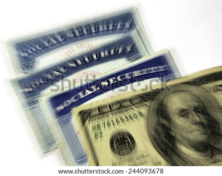 Detail of several Social Security Cards and cash money symbolizing retirement pensions financial safety