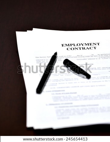 Employment Contract document and agreement with pen for signing