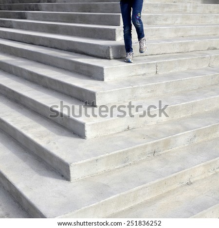 Person walking down concrete steps of law building