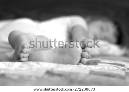 Portrait of little girl sleeping with focus on feet