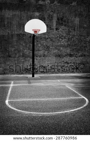 Detail of urban basketball hoop inner city innercity wall and asphalt in outdoor park