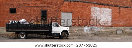 Detail panorama of work truck and brick wall