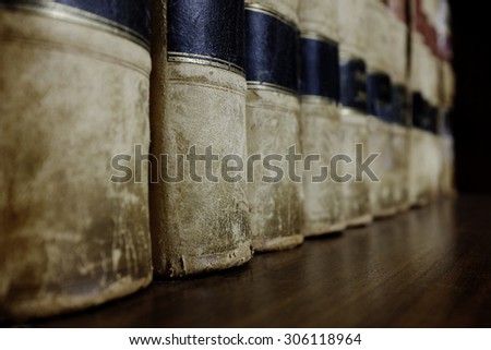 Long row of old leather law books on a shelf