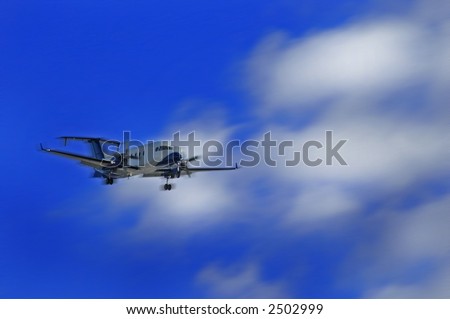 Airplane with landing gear flying with sky and clouds in background