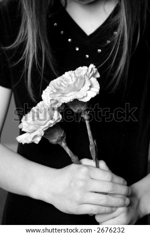 stock photo : Closeup of girl with long hair holding flowers in her hands