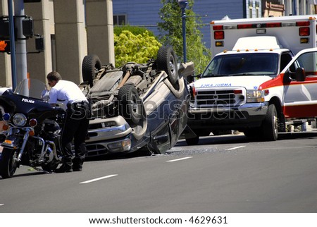 Car Wreck with Rolled Car Police and Ambulance