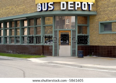 Bus depot sign hanging over doorway to building