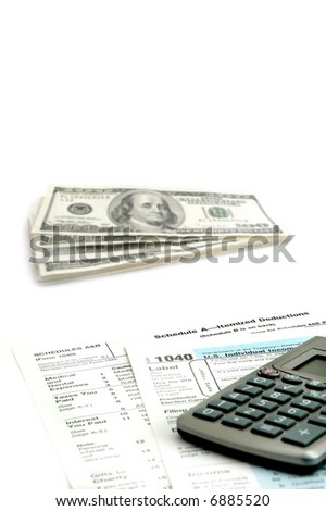 Detail closeup of current tax forms, calculator and cash