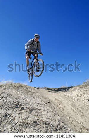 Man mountain biking on trail in outdoors