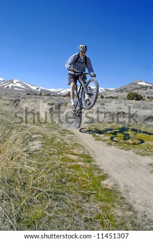 Man mountain biking on trail in outdoors
