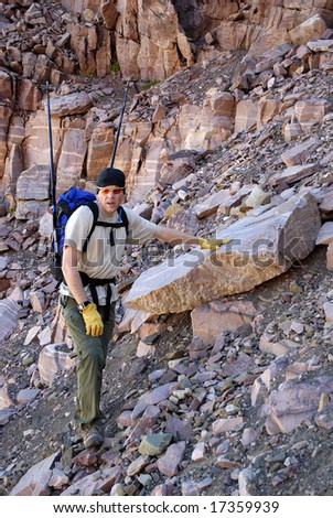single person climbing along rocky ridge on a trail