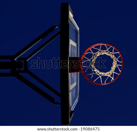 Basketball hoop and net with blue sky in background