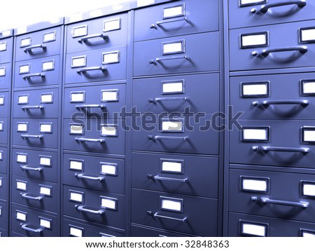 Rows of metal business filing cabinets with handles and lables