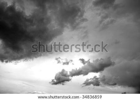 Dark storm clouds in sky with light in the center