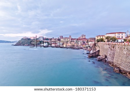 long exposure of Piombino town in Tuscany, Italy, seen from Piazza Bovio, terrace built on promontory on Mediterranean sea