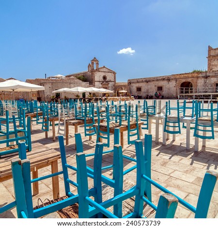 MARZAMEMI, ITALY -  AUGUST 19, 2014: tourists visit main square in Marzamemi, Italy. It is a small village just a few kilometres from Italy's southernmost point, in the deep south-east of Sicily.