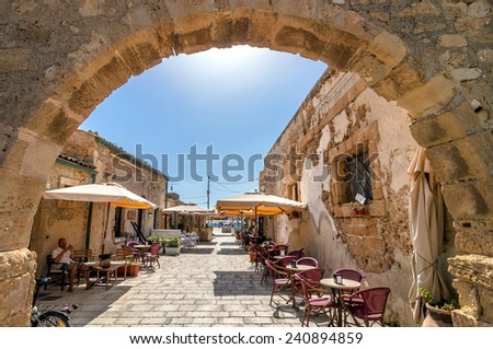 MARZAMEMI, ITALY -  AUGUST 19, 2014: tourists visit old village in Marzamemi, Italy. It is a small fishing village close to Italy\'s southernmost point, in the deep south-east of Sicily