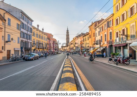 PARMA, ITALY - SEPTEMBER 10, 2014: day view of downtown main street with shops and citizens in Parma, Italy. Parma is famous for its prosciutto (ham), cheese, architecture and music