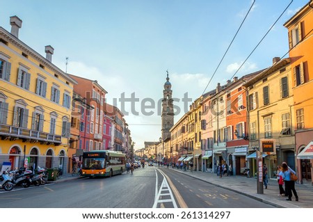 PARMA, ITALY - SEPTEMBER 10, 2014: Day view of downtown main street with shops and people in Parma, Italy. Parma is famous for its prosciutto (ham), cheese, architecture and music