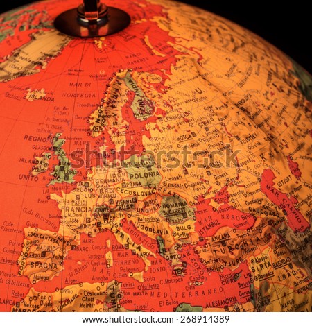 MILAN, ITALY - DECEMBER 17, 2014: vintage red world globe illuminated with closeup on Europe  in Milan, Italy.  A globe is the only representation of the earth that does not distort its shape or size